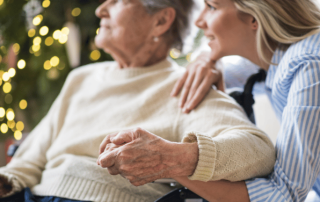 Elder women and young woman holding hands during the holidays