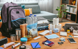 Contents of an emergency kit organized on a table before being put into its designated bag.