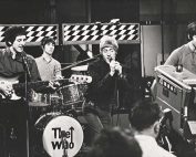 Black and white image of The Who performing live.
