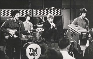 Black and white image of The Who performing live.