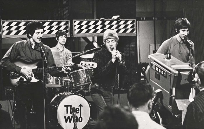 Black and white image of The Who performing live.