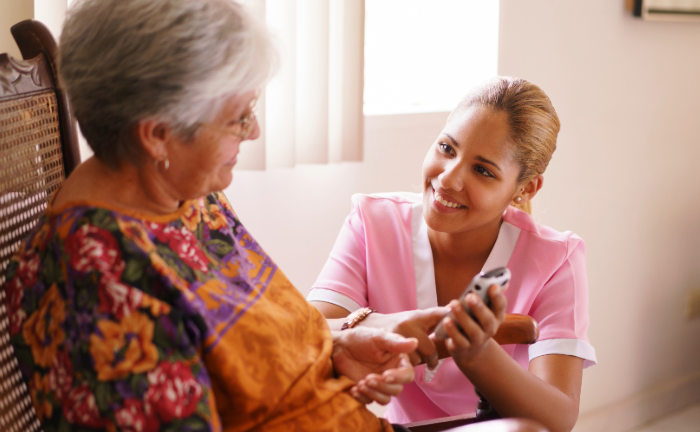 A care giver attending to an elderly patient