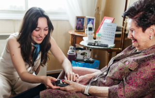 Care giver taking an elderly womans vitals.