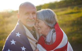 Veteran and wife wrapped in flag.